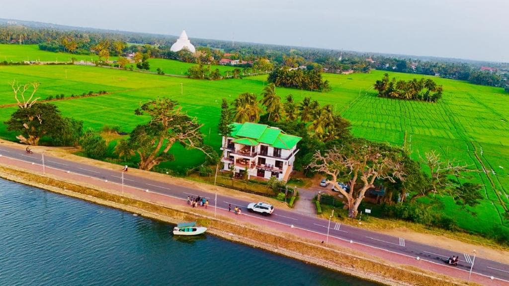 Tissa Lake in Tissamaharama with local tuk-tuks and the town's main street showing the base for Yala National Park visitors