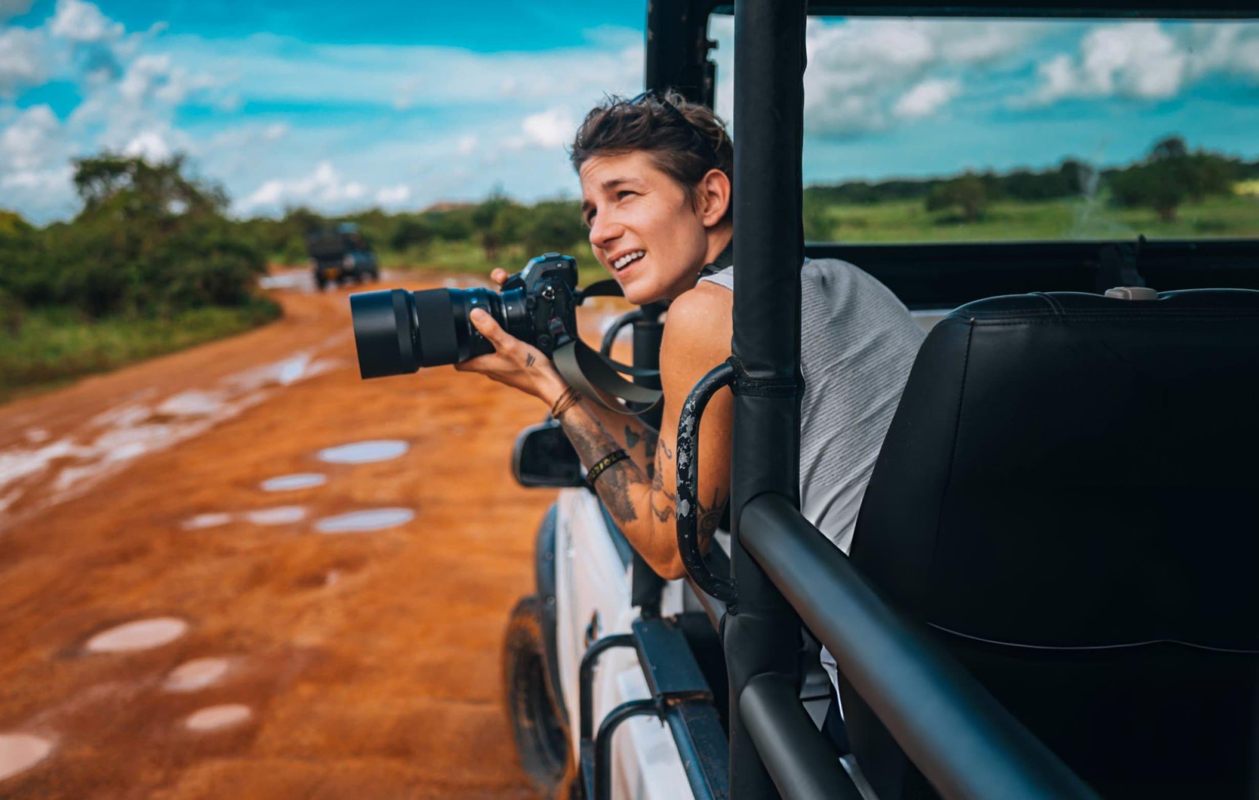 Camera equipment setup inside a private safari jeep at Yala National Park with telephoto lens mounted on window support